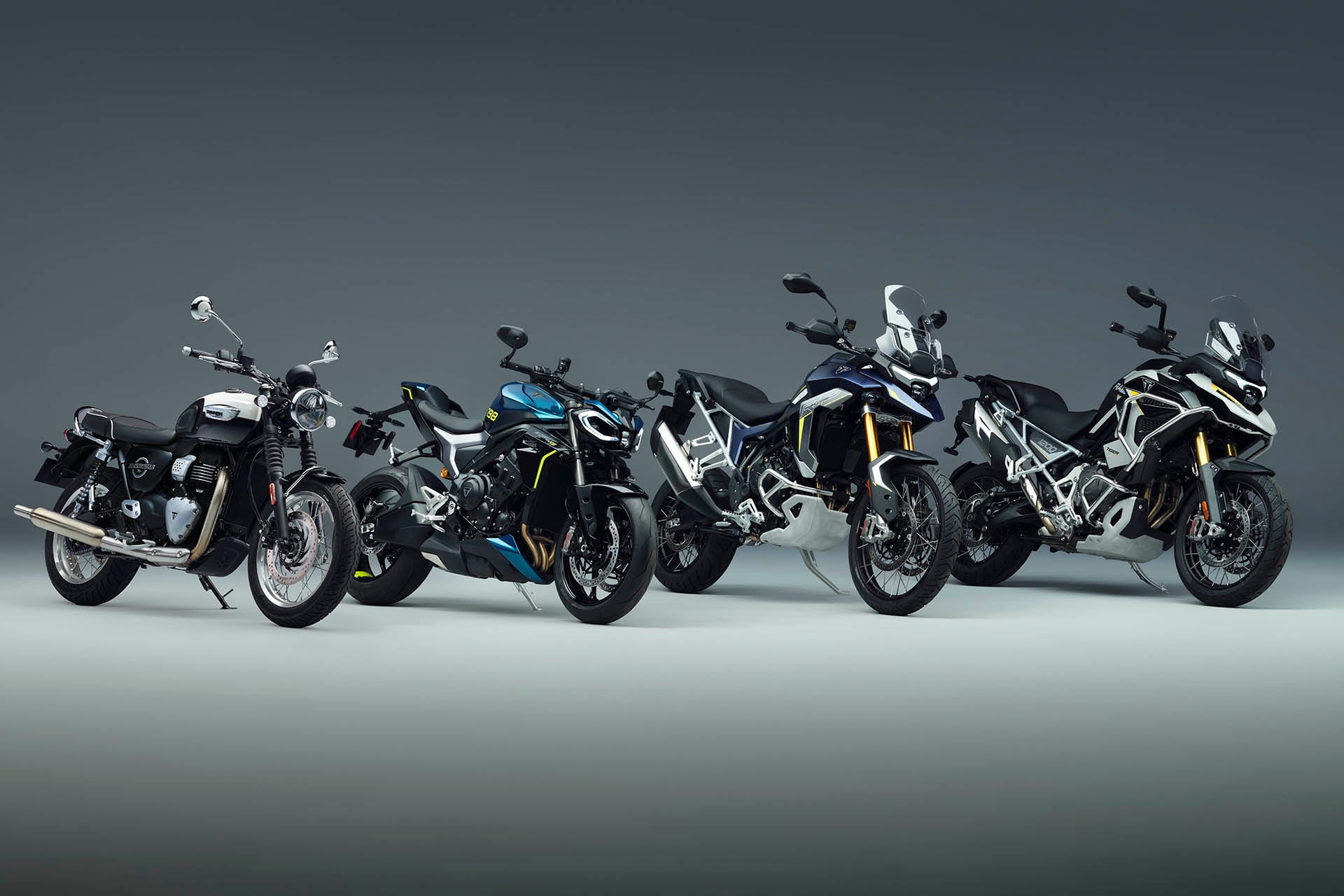four bikes in the spot light on a shadowy setting