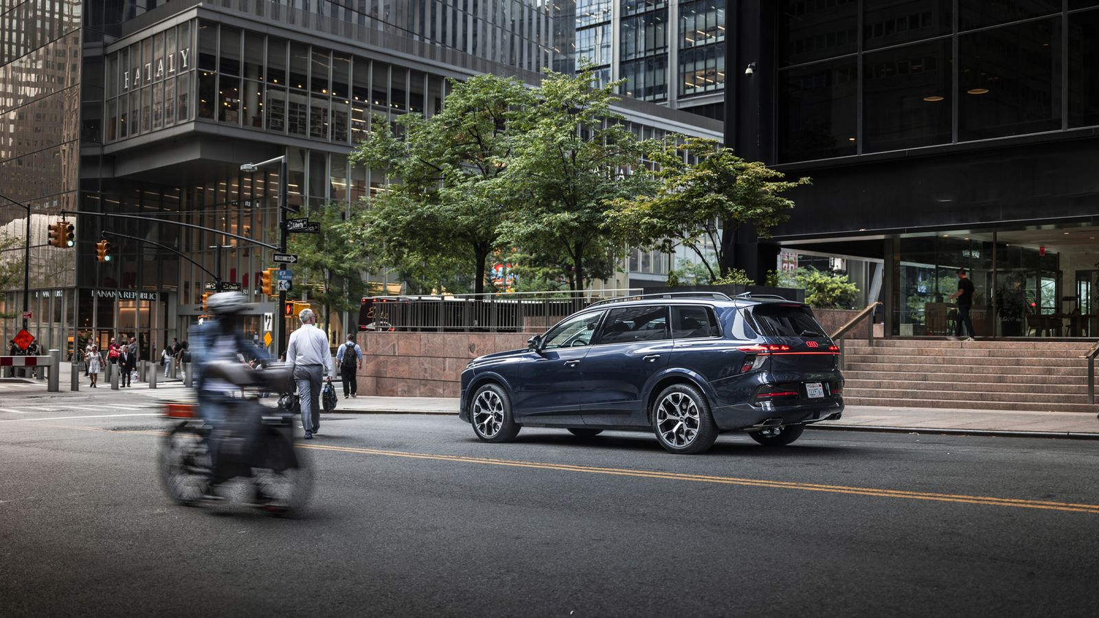 Rear three-quarter view of the Audi Q9 parked on a city street