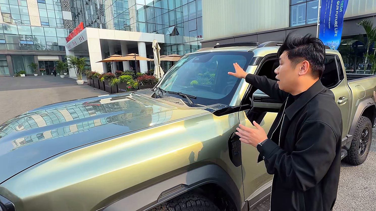 Mark Qi pointing at the Chery Stockman A-pillar mounting points for light bars