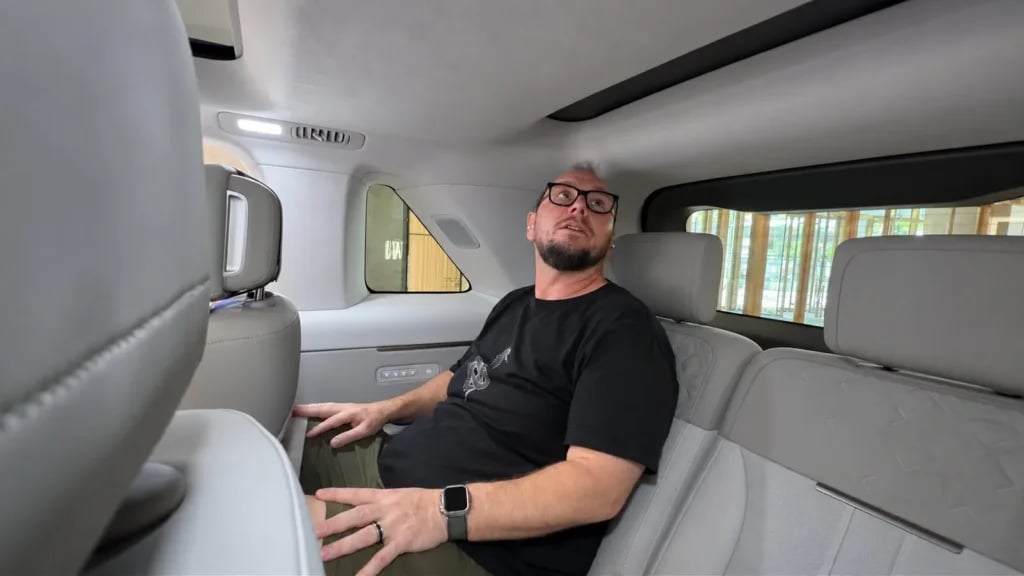Richard Edwards sitting in the Freelander 8 third row, showing headroom