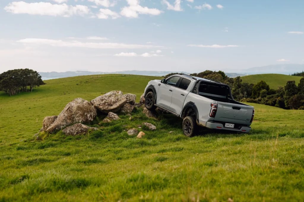 GWM Cannon Hi4-T PHEV with a wheel up on a rock outcrop