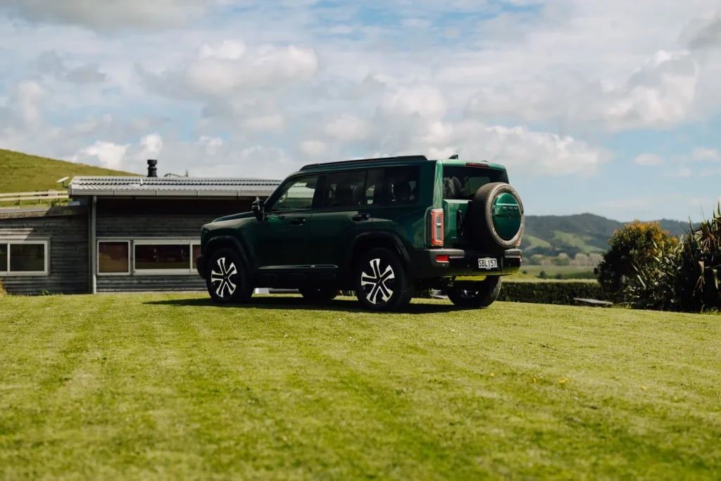 Emerald Green Haval H7 parked beside a rural farmhouse