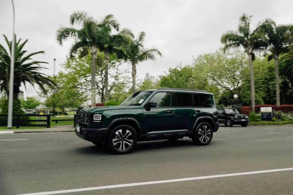Emerald Green Haval H7 driving on a suburban street