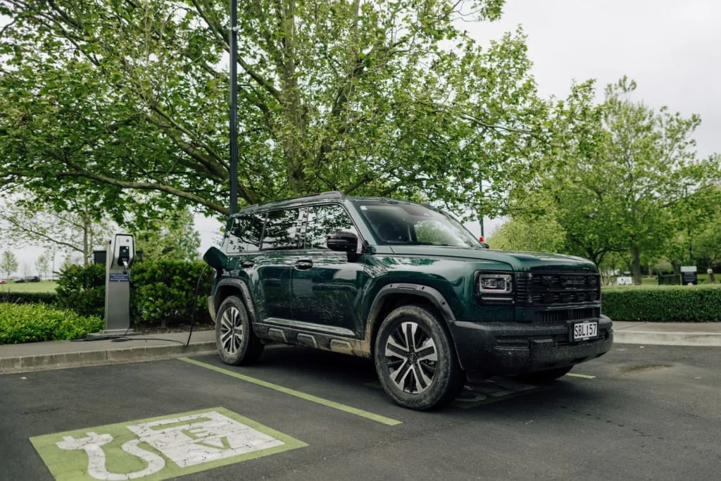 Emerald Green Haval H7 PHEV plugged in at a public EV charger