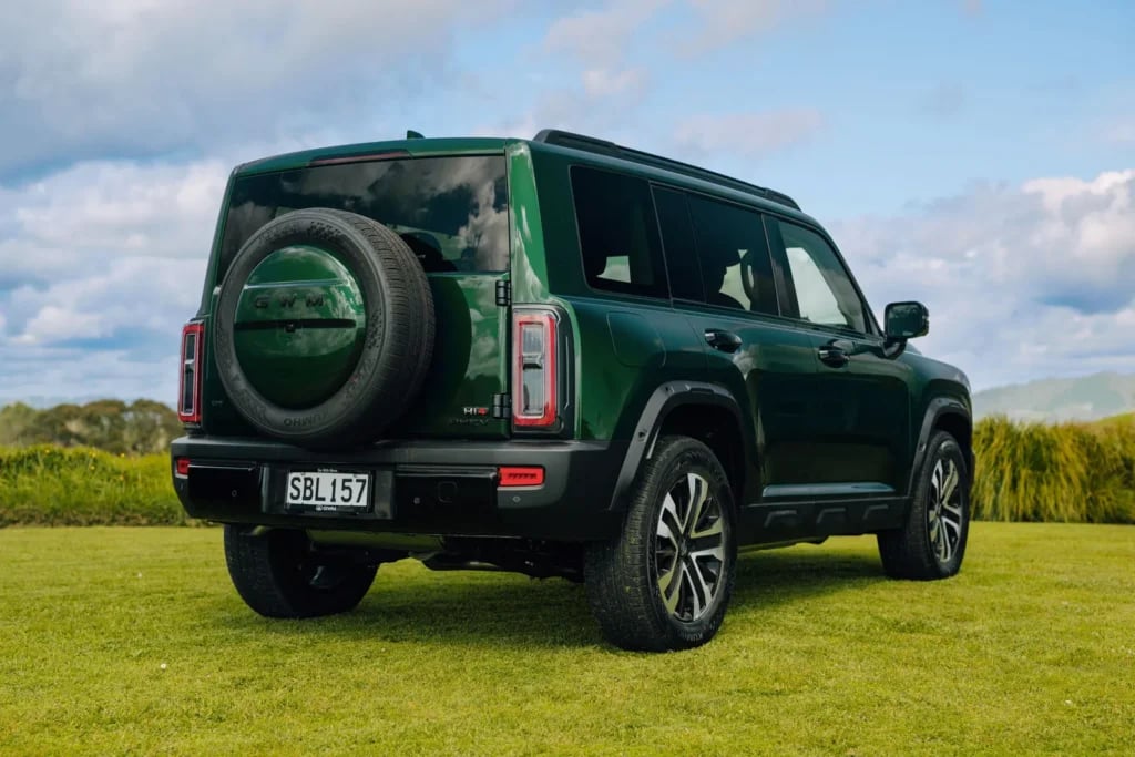 Rear view of the Emerald Green Haval H7 showing the tailgate-mounted full-size spare