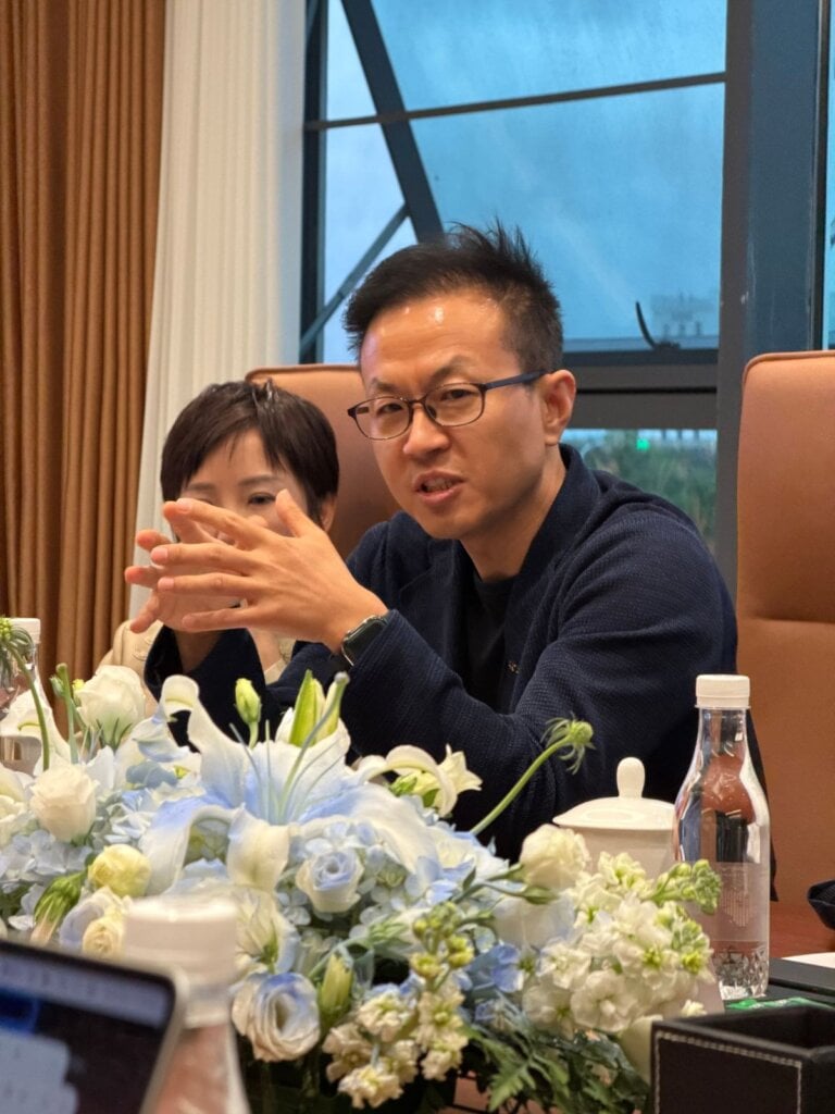 Su Jun gesturing while speaking at an iCAUR media round table