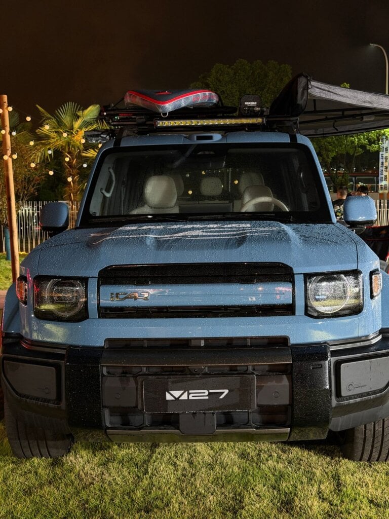 Blue iCAUR V27 front view with roof rack, light bar and awning
