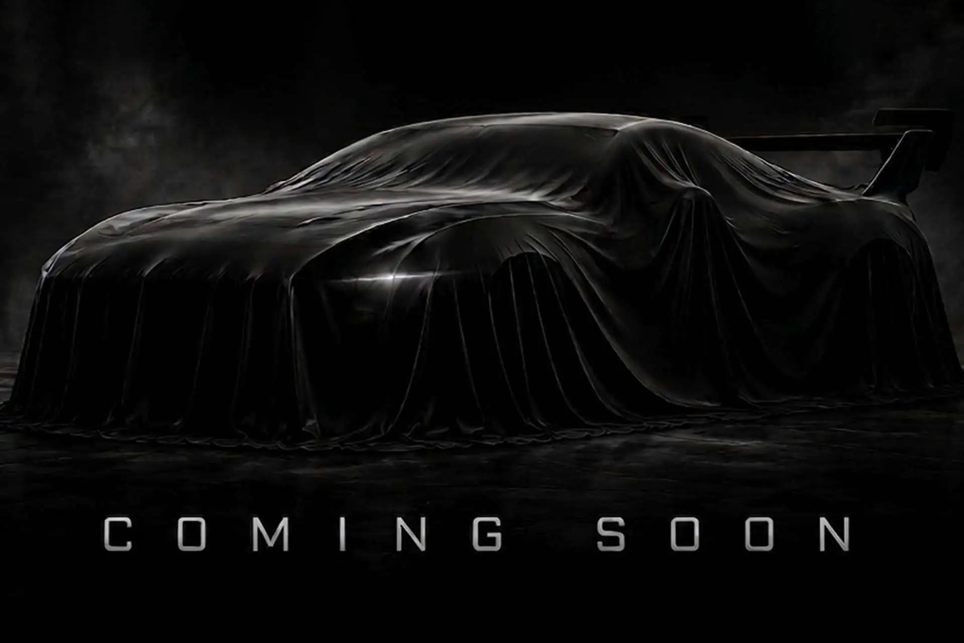 mustang in black under a shroud