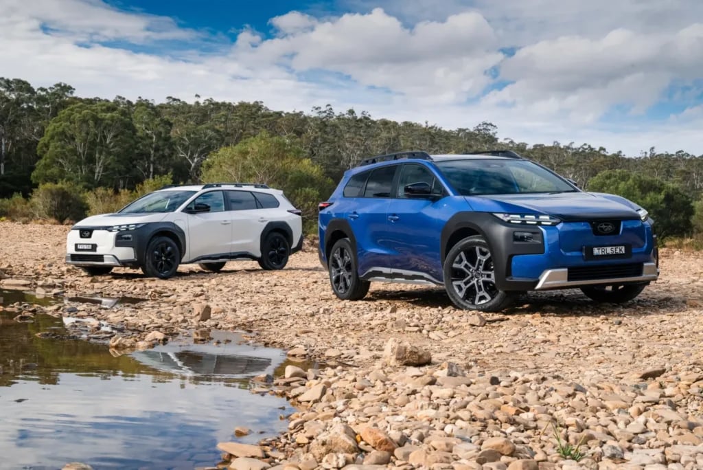 Subaru Trailseeker AWD in white and AWD Touring in blue parked on a rocky riverbed