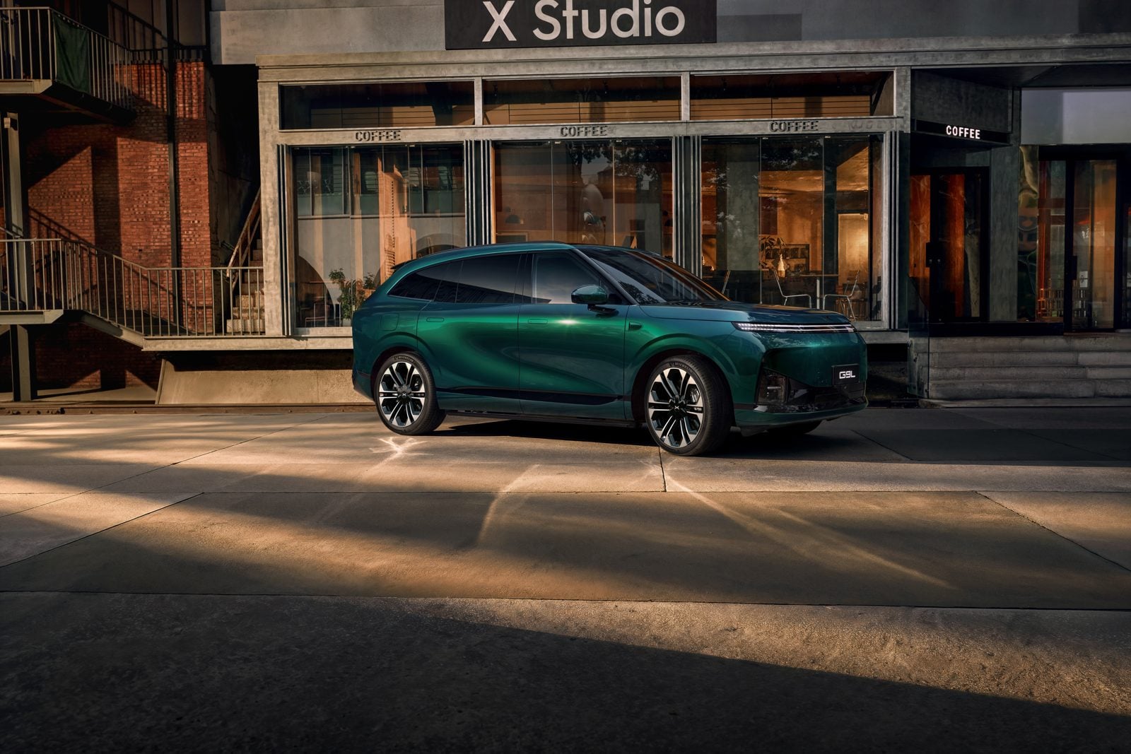 Green XPeng G9L parked outside a building