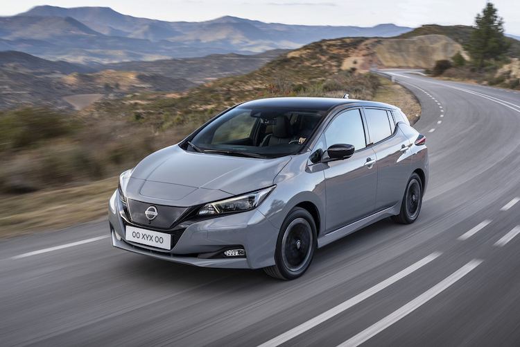 Nissan Leaf electric hatchback driving on a coastal road