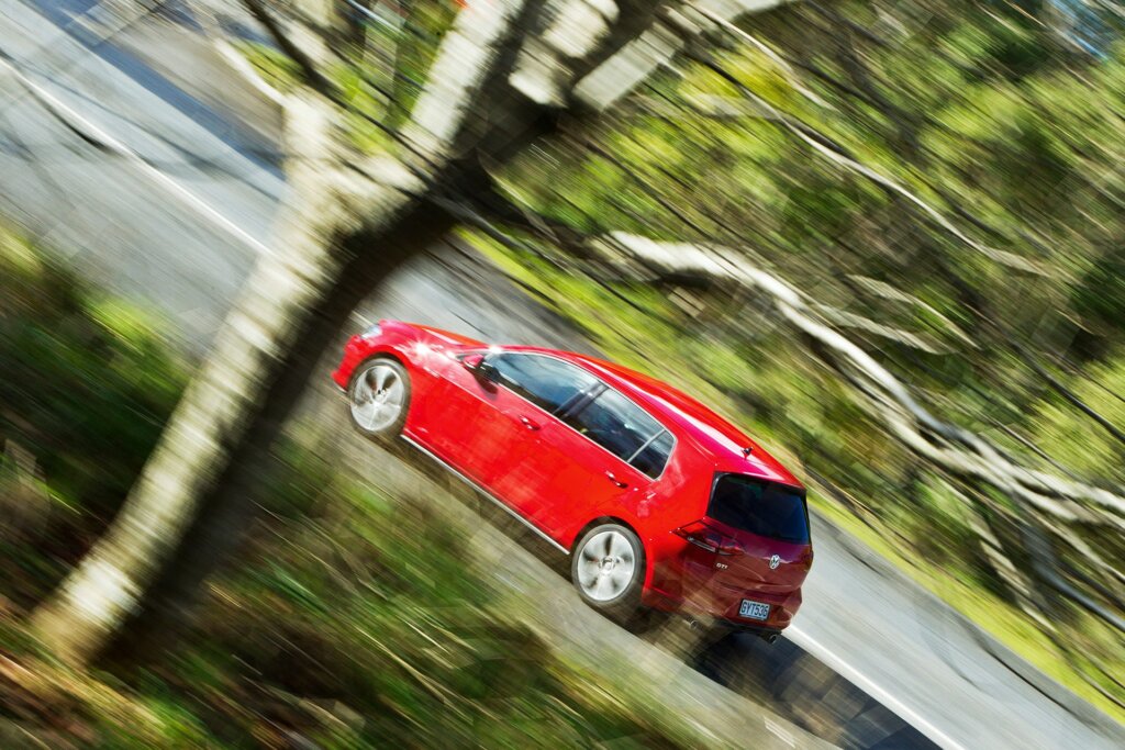 2013 VW Golf GTI driving past trees
