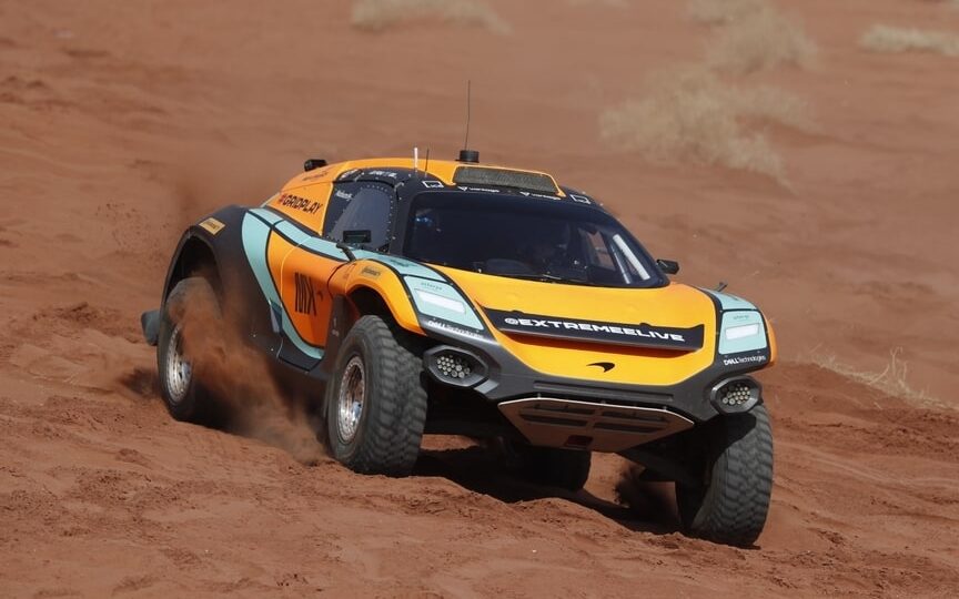 McLaren Extreme E car racing in desert front three quarter view