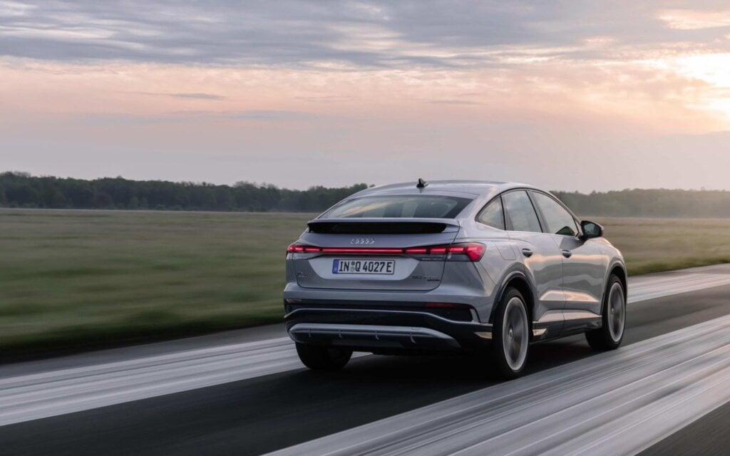 Audi Q4 e-tron Sportback rear three quarter view driving on runway