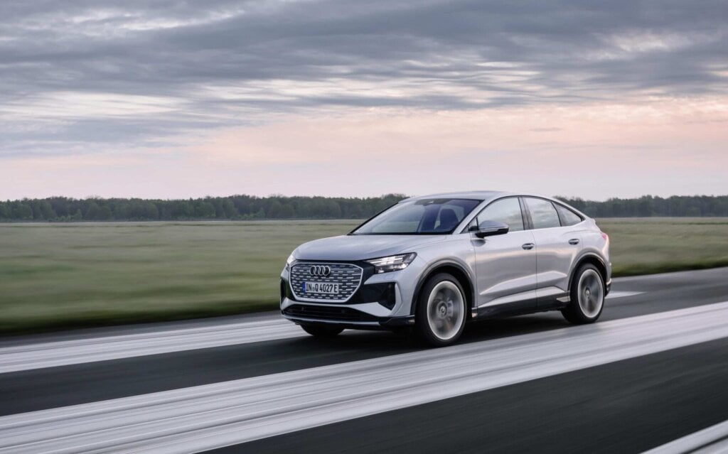 Audi Q4 e-tron Sportback front three quarter view driving on runway