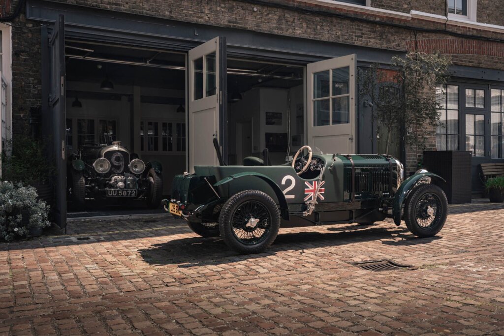Bentley Blower Jnr parked in front of garages with original car