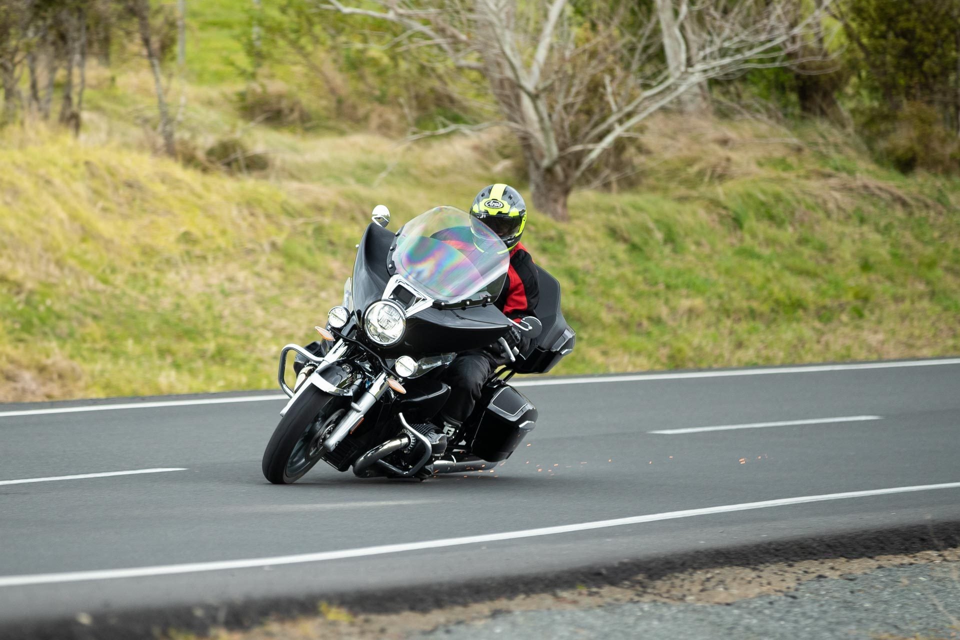 BMW R18 Transcontinental taking a corner, with sparks flying