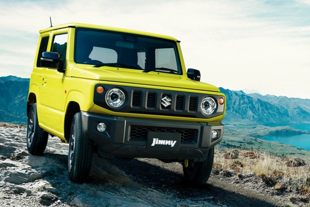 Suzuki Jimny kei car driving over rocks
