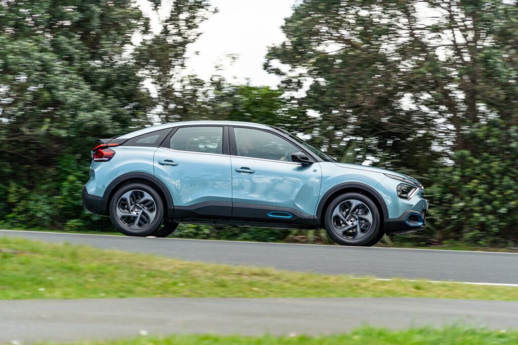 Citroen e-C4 Shine side profile panning shot