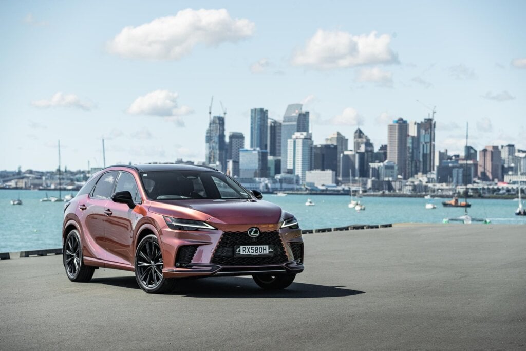 Lexus RX 500h front quarter in front of Auckland's city skyline