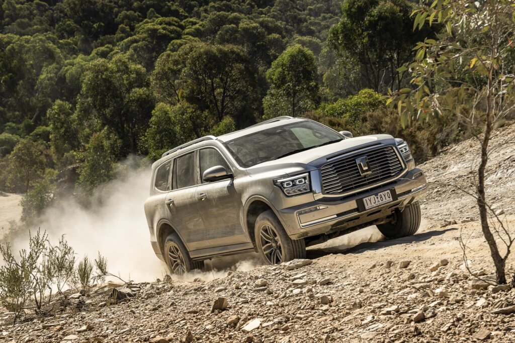 GWM Tank 500 Ultra on a dirt track, moving with a dust cloud