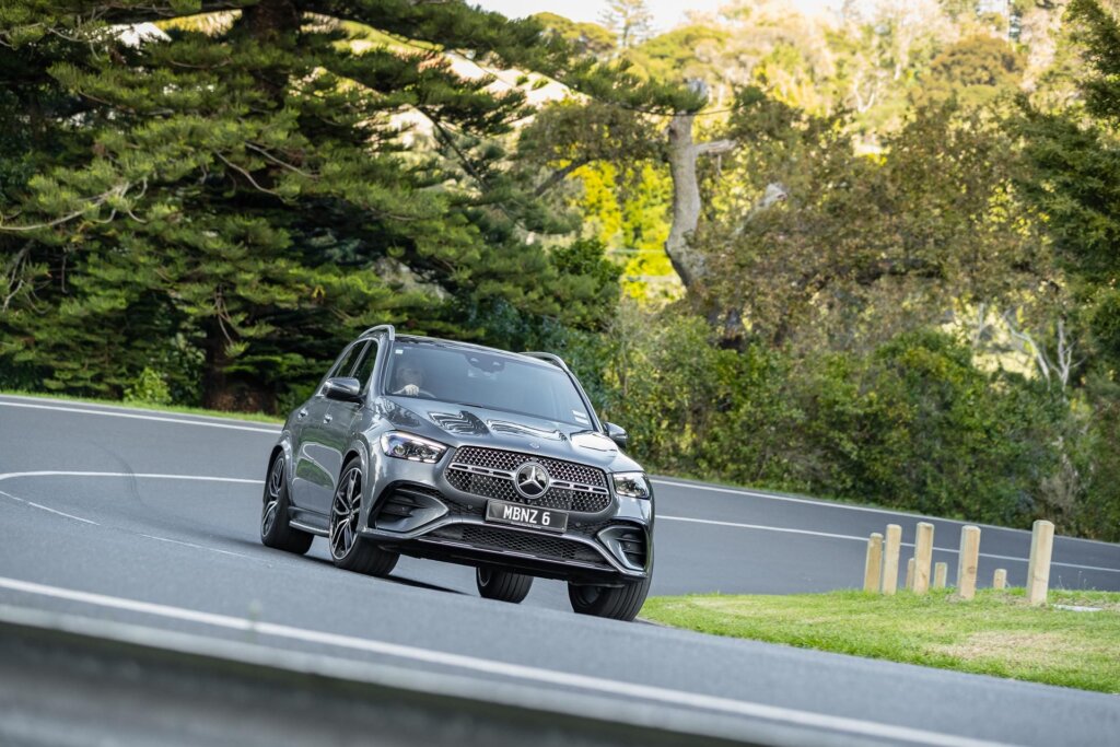 Mercedes-Benz GLE 450 d 4MATIC front quarter angle in silver, cornering on a long curve