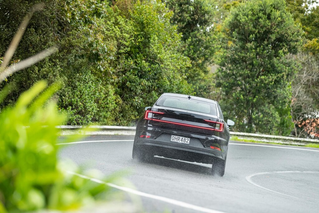 2024 Polestar 2 Long Range shown from the rear, taking a corner at pace