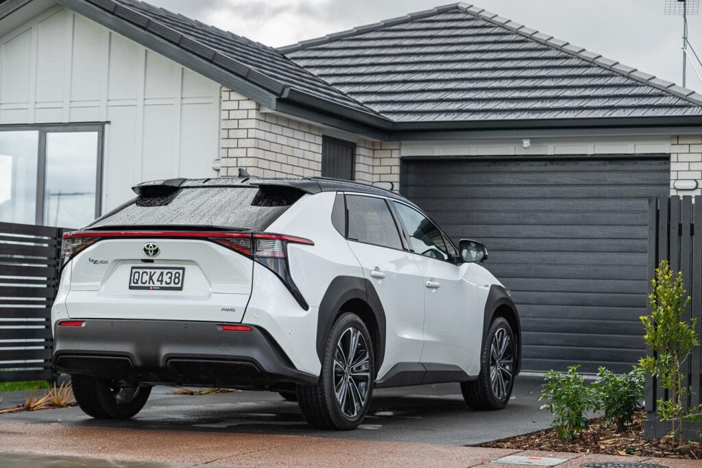 Toyota bZ4X Pure rear view parked at a house