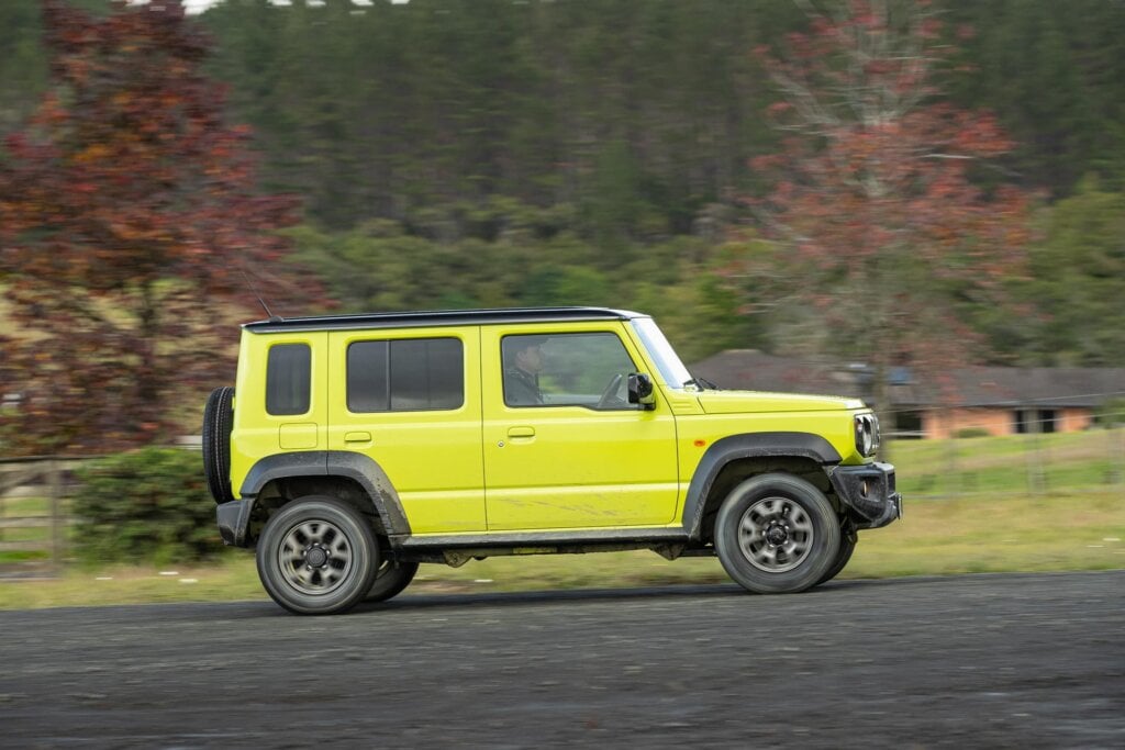 Side profile of the Suzuki Jimny 5-door driving past