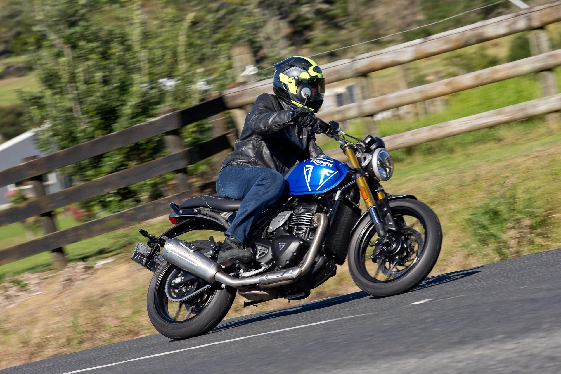 Triumph cornering at speed, blue