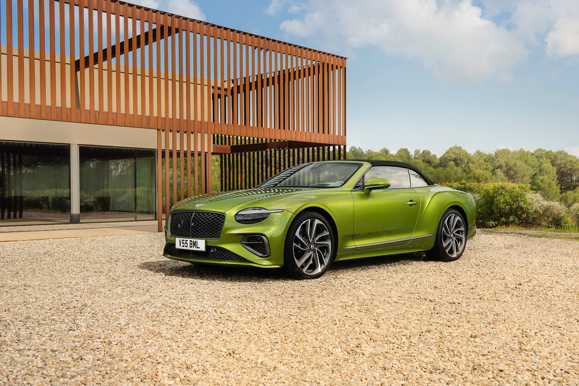 Bentley Continental GTC Speed at rest on pebbled driveway.