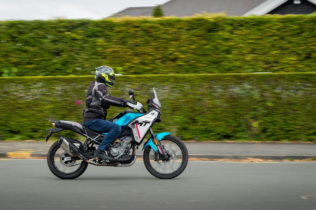 CFMoto 450MT panning shot, riding past
