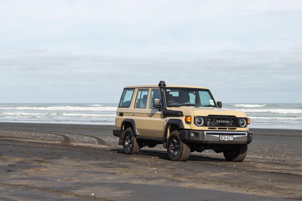 Toyota Land Cruiser 70 LX parked on a New Zealand beach