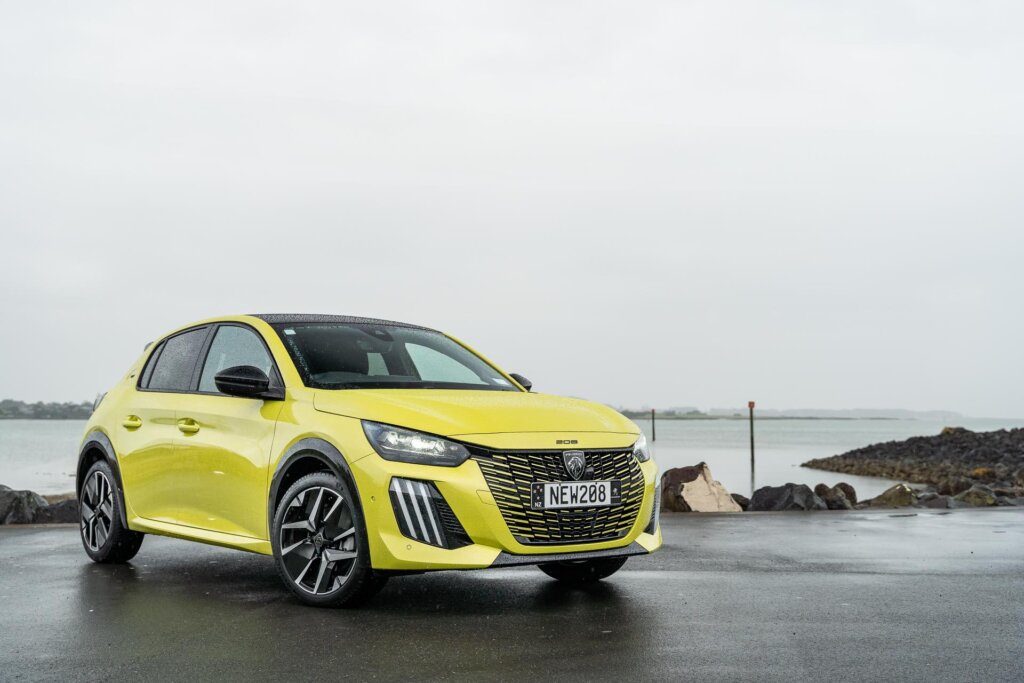 Front quarter view of the 2024 Peugeot 208 GT Hybrid pictured in yellow