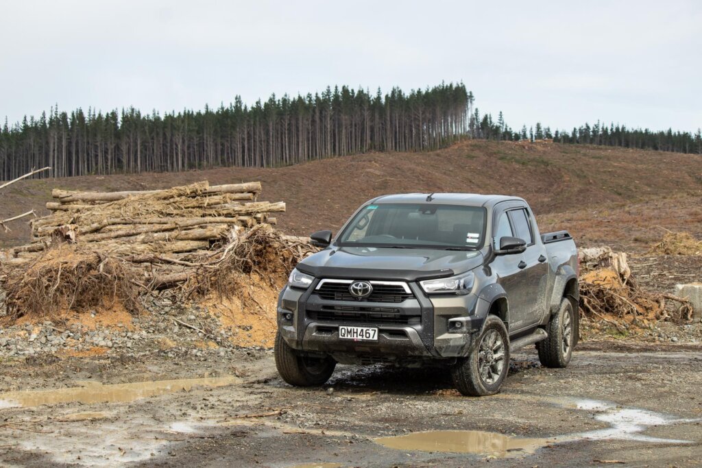 2024 Toyota Hilux SR5 Cruiser Hybrid in beige, parked in mud