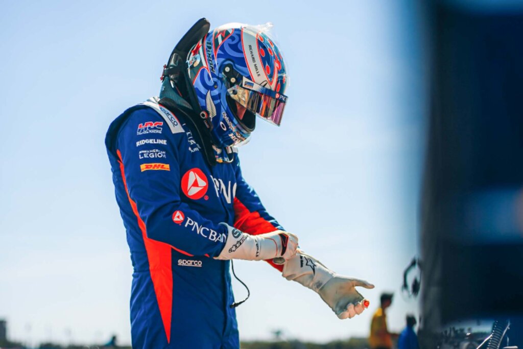Dixon putting on his gloves, wearing full race gear