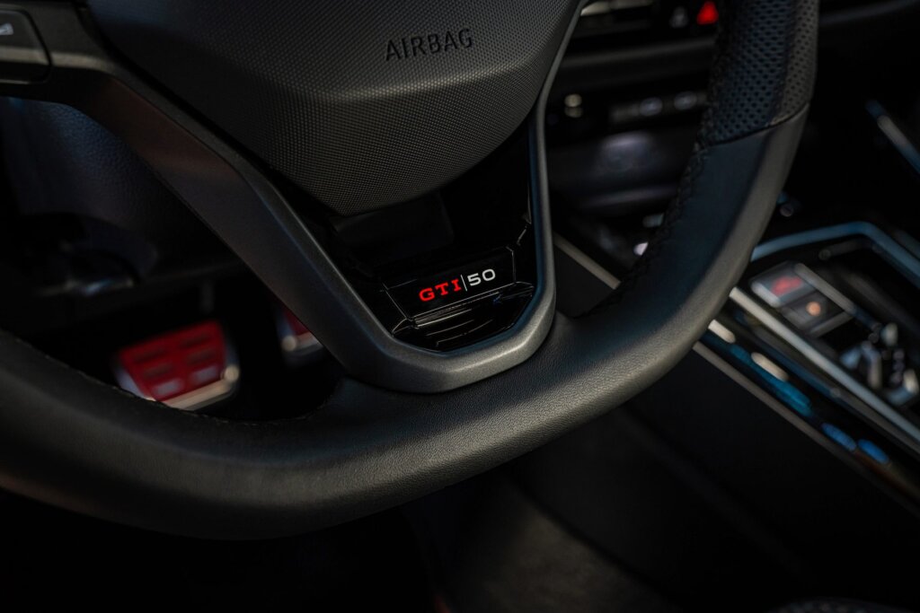 GTI 50 logo on the wheel, and scuff plates.