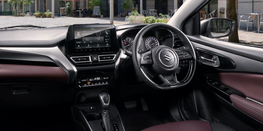 Analogue instruments and tall gear stick age Fronx a little but easy to use interior.