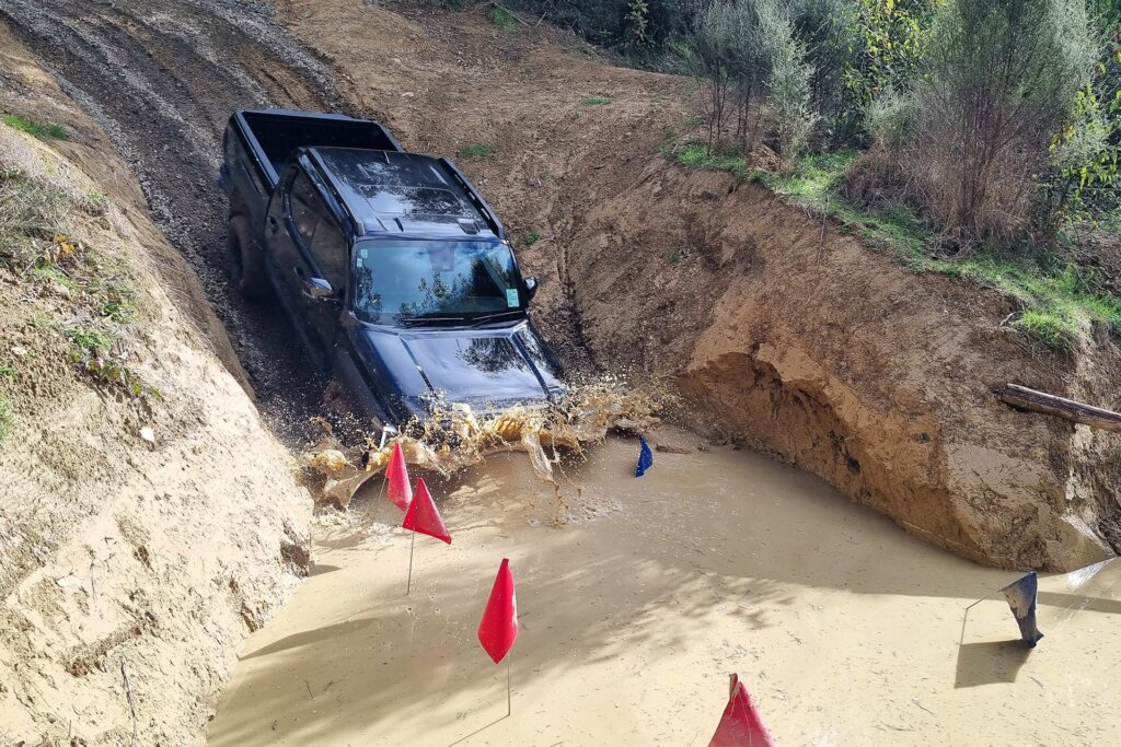Kia Tasman in muddy water