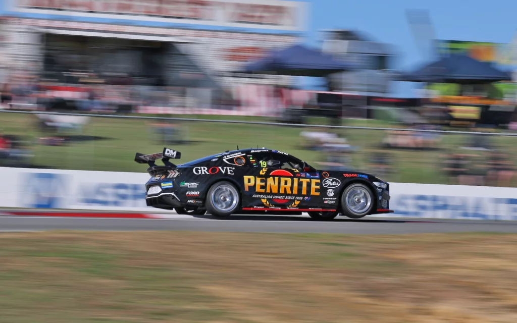 Matt Payne up on two wheels during Supercars racing.