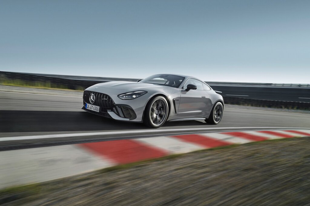 AMG GT on track with a red and white ripple strip in the foreground