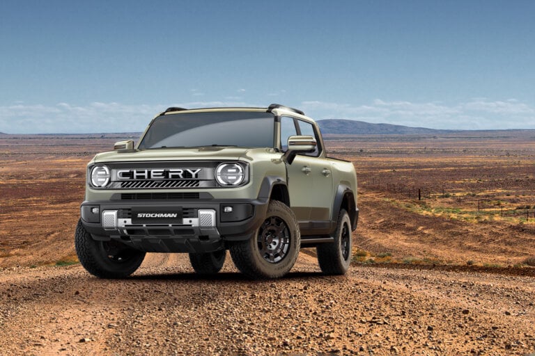 Stockman ute in green on a dusty road in the outback