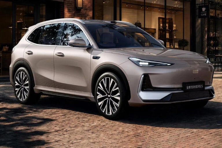 a silver-ish Geely on brown cobblestones