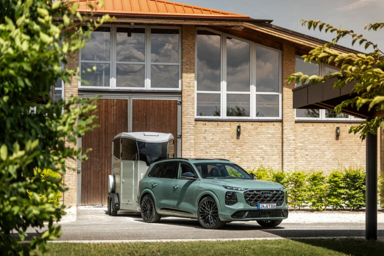 green audi towing a silver horse float