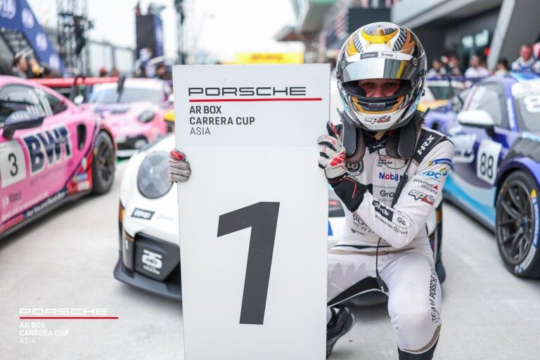 race driver with a helmet in the pits