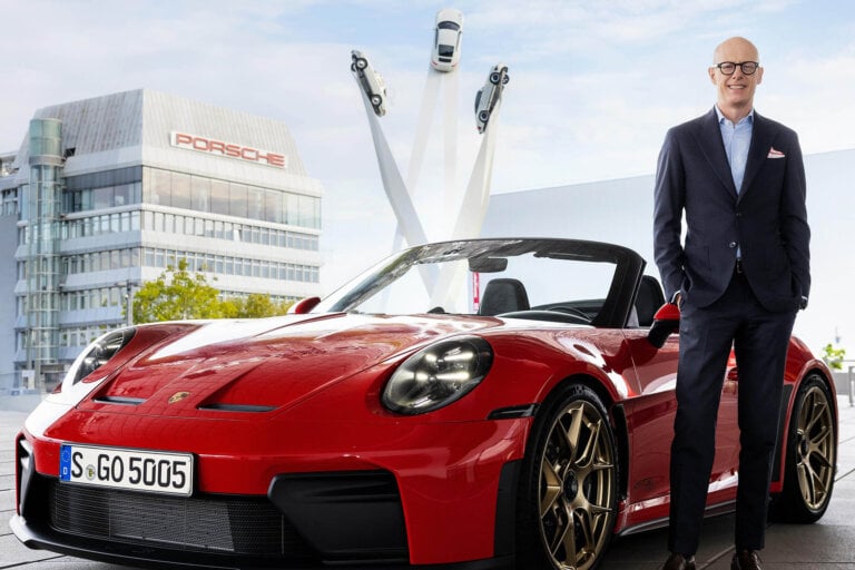 bald guy next to red 911