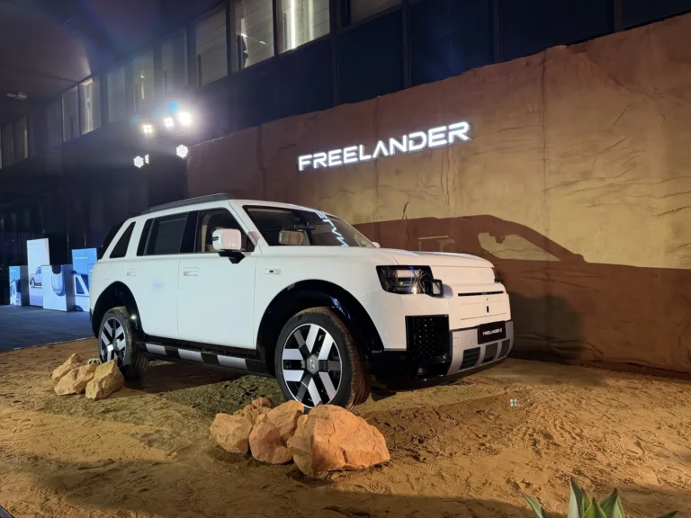 White Freelander 8 SUV front three-quarter view on a sand display at the Wuhu international launch