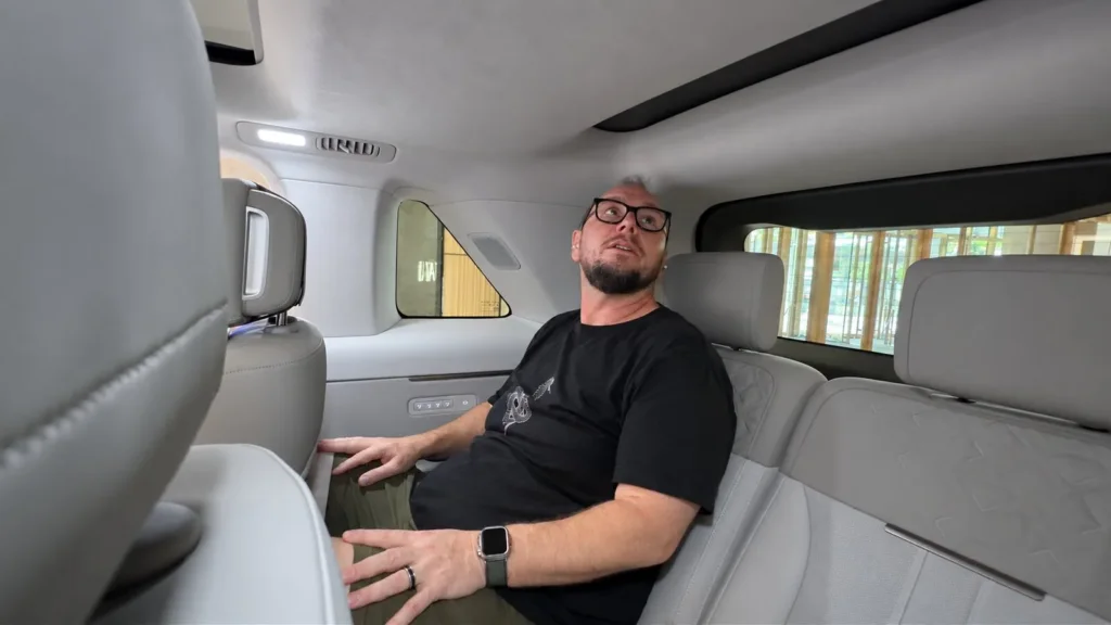 Richard Edwards sitting in the Freelander 8 third row, showing headroom