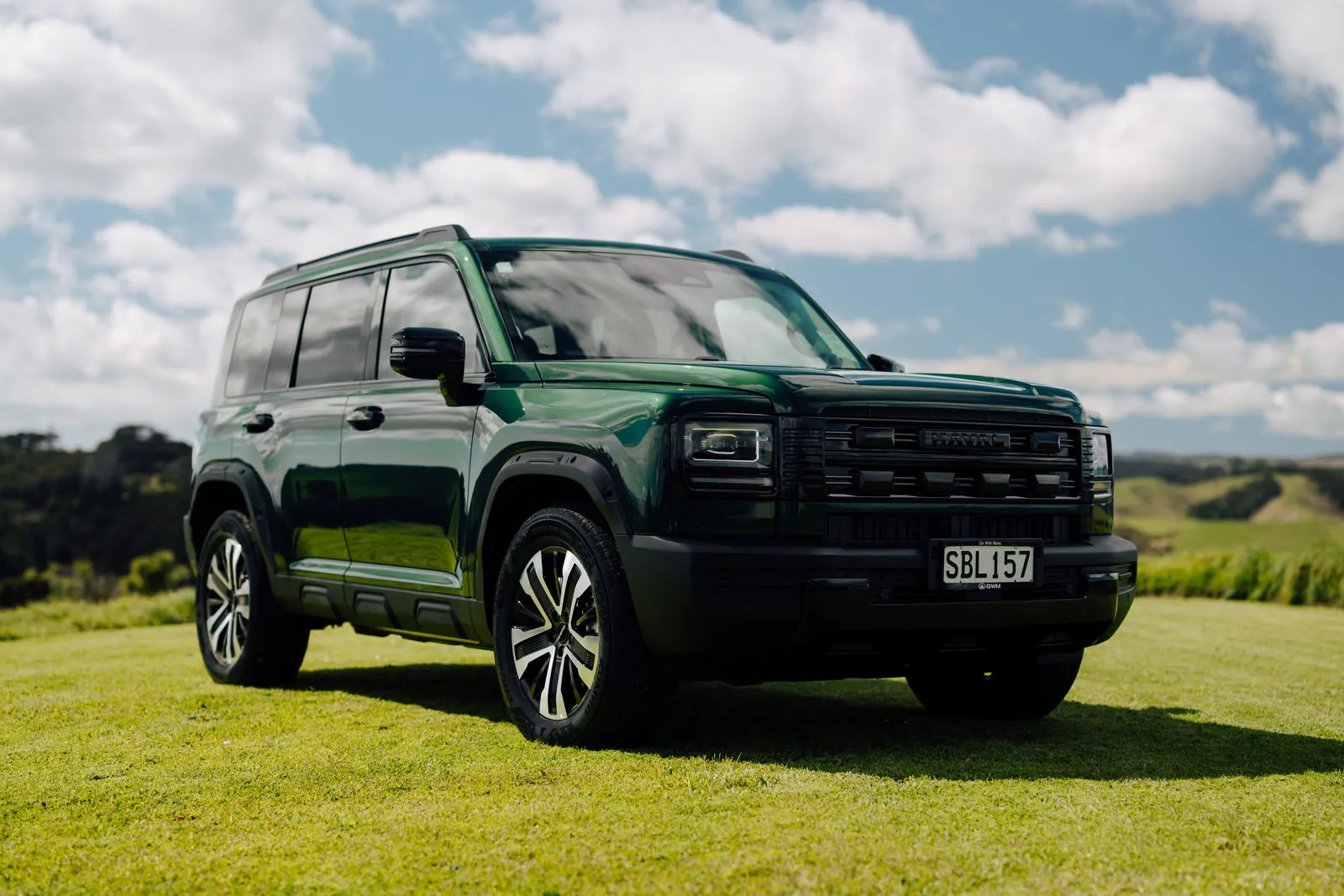 Emerald Green Haval H7 parked on farmland at the New Zealand launch