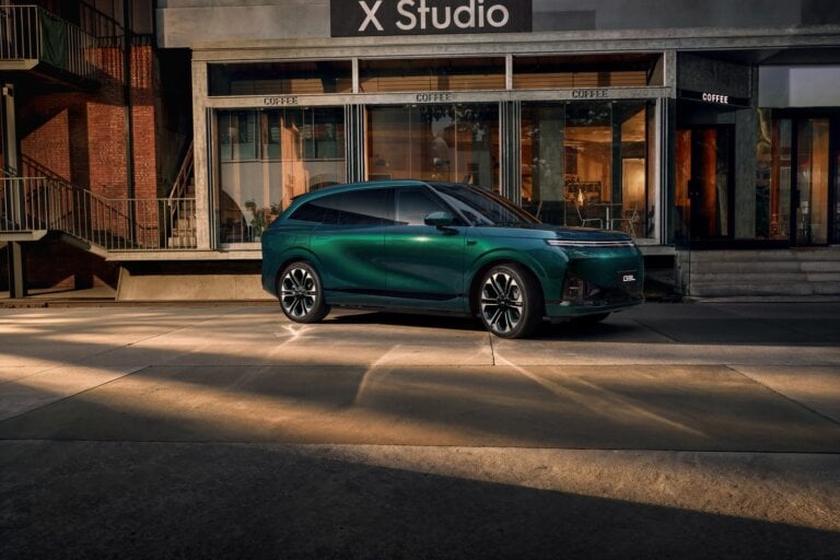 Green XPeng G9L parked outside a building